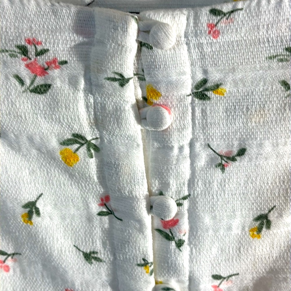 White miniskirt, full button front with pink and yellow floral pattern